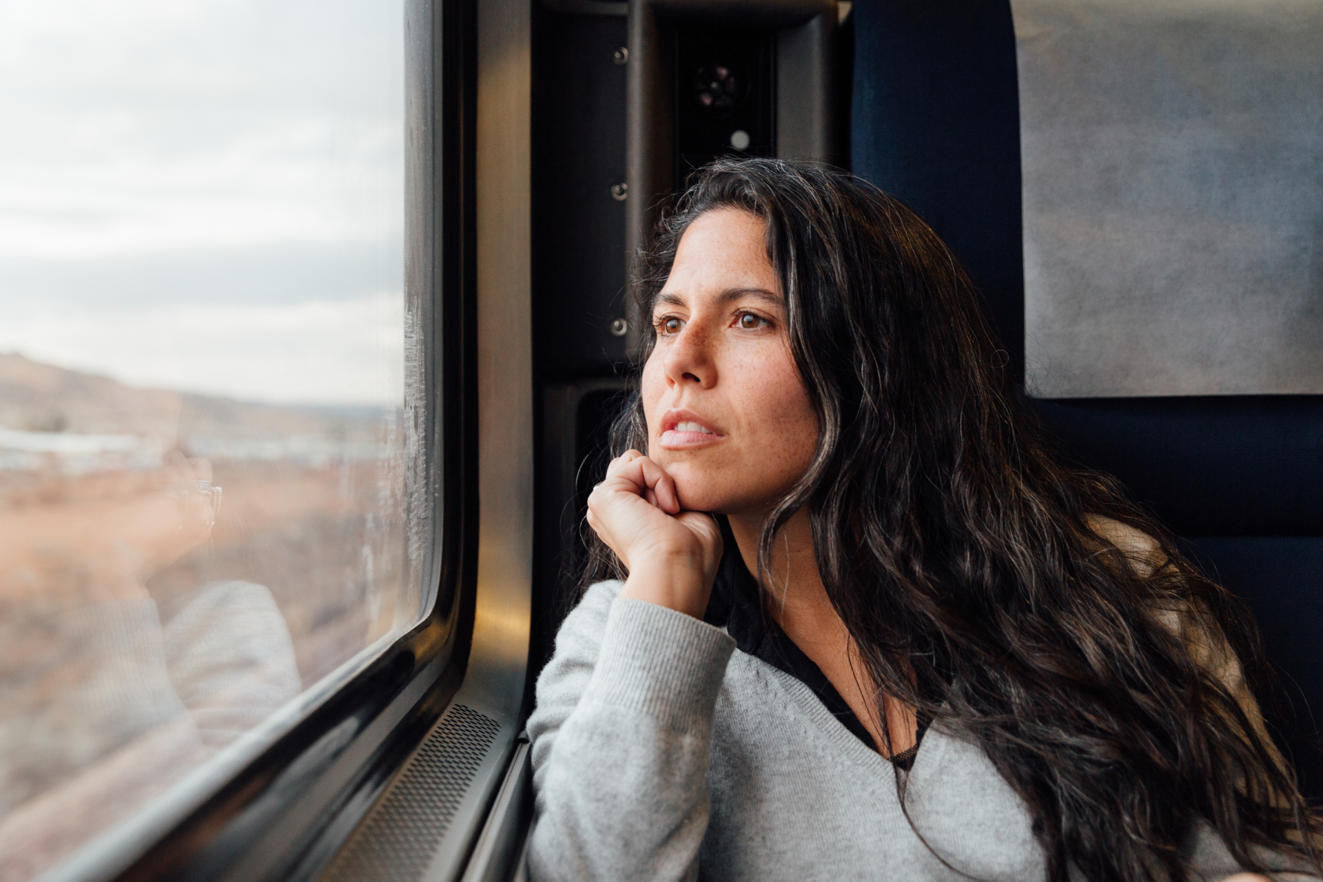 Woman looking out train window